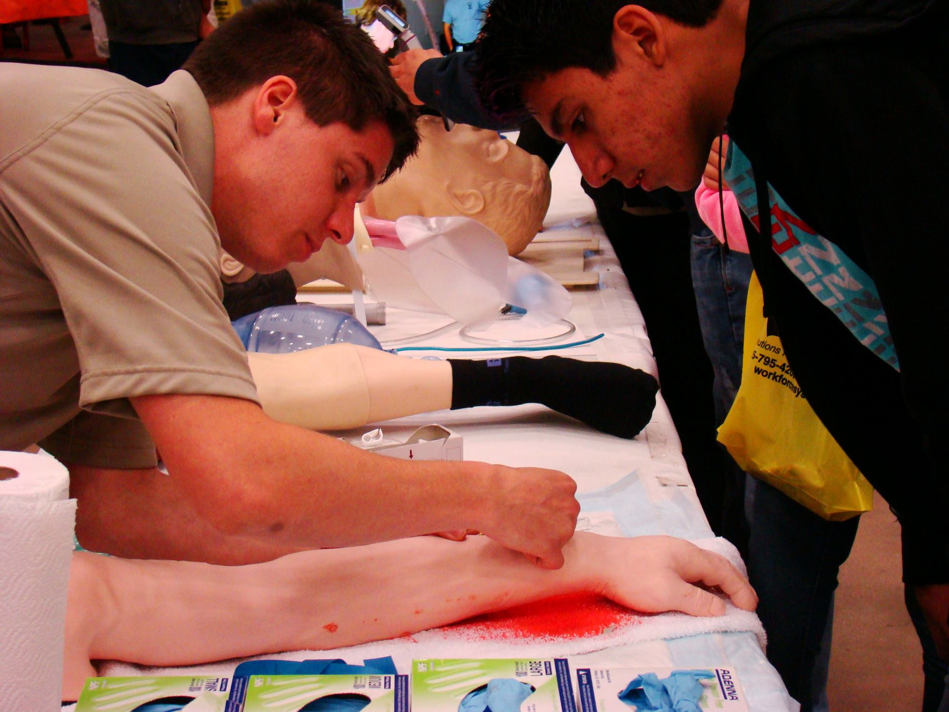 Student receives instruction during demonstration of stitches.